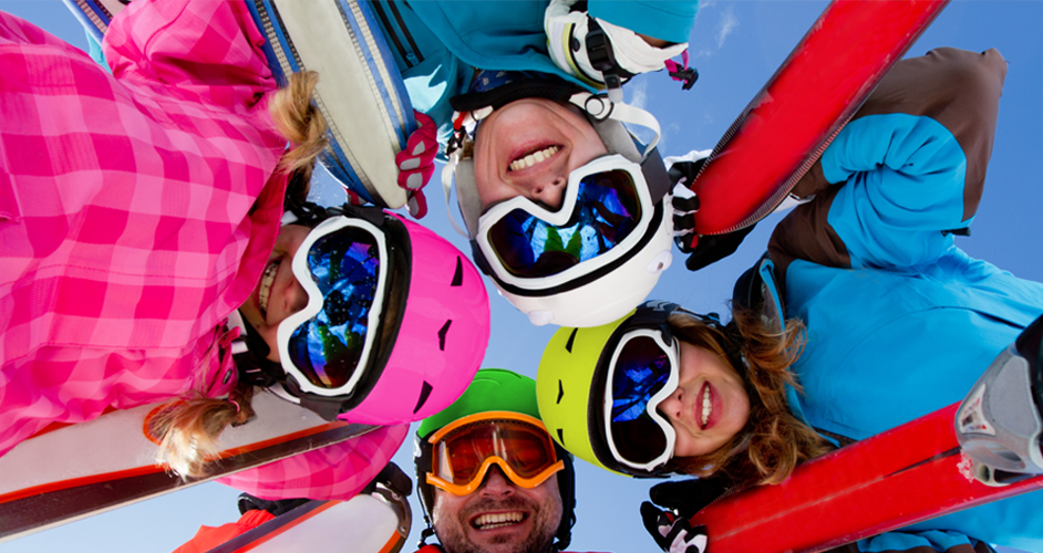 Image of a group of people in a circle with skis.