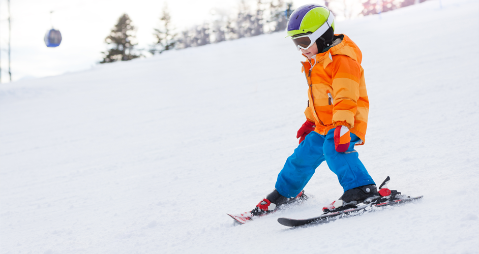 Image of a boy learning to ski.