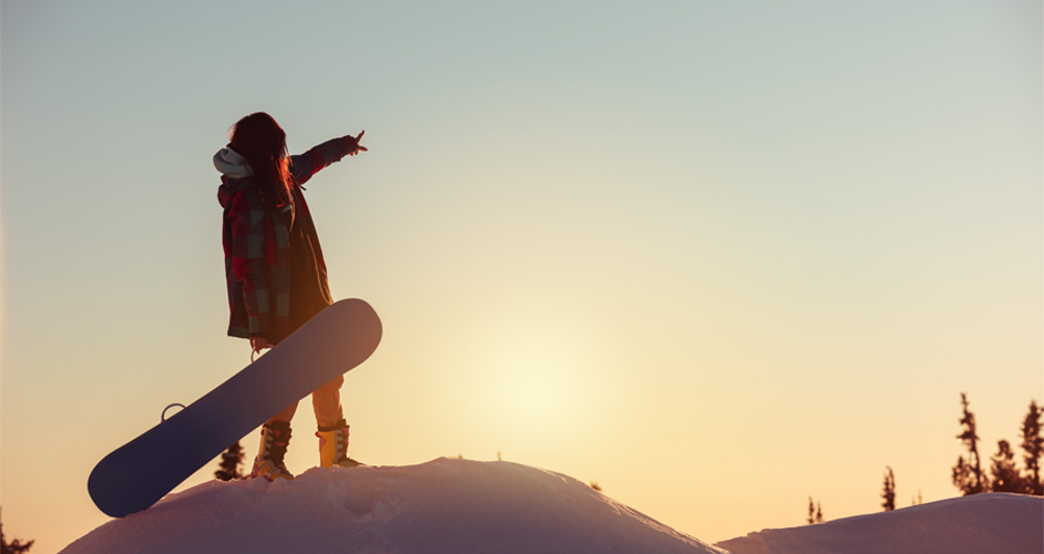 Image of a person holding their snowboard.