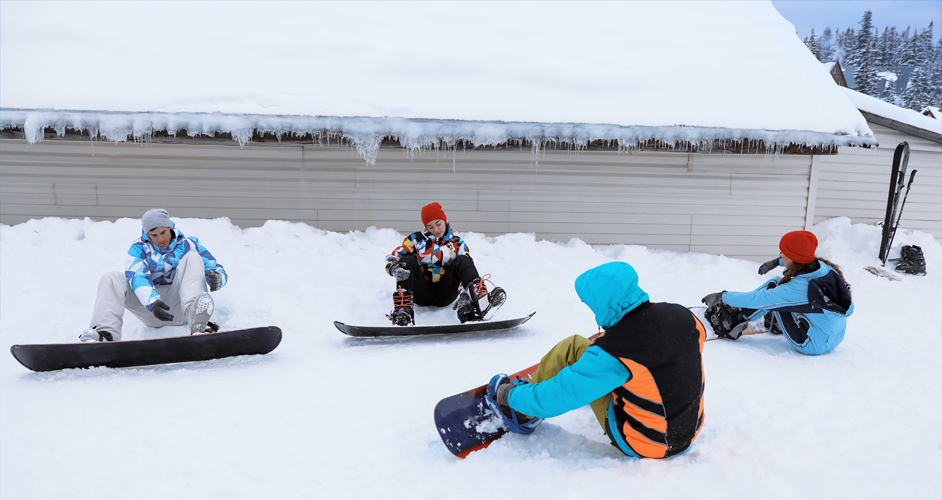 Image of a group of people having a snowboarding lesson.